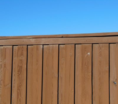 a wooden fence with a blue sky in the background